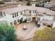 Exterior aerial view of a grand estate with circular driveway and meticulously manicured landscaping at 9325 Verlaine Ct, Las Vegas, NV 89145