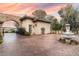 Charming guesthouse featuring a stone archway, decorative fountain, and lush landscaping at 9325 Verlaine Ct, Las Vegas, NV 89145