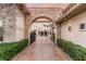 Impressive estate entrance with stone archway, iron gate, and patterned concrete driveway at 9325 Verlaine Ct, Las Vegas, NV 89145