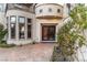 Elegant front entrance featuring decorative iron doors, manicured landscaping, and patterned concrete at 9325 Verlaine Ct, Las Vegas, NV 89145