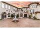 Elegant home featuring a circular driveway with fountain, arched windows, and a Juliet balcony at 9325 Verlaine Ct, Las Vegas, NV 89145