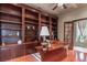 This home office features custom built-in shelves, a unique desk, and hardwood floors at 9325 Verlaine Ct, Las Vegas, NV 89145