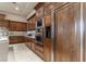 Kitchen area with wood cabinets, built in appliances, and granite countertops at 9325 Verlaine Ct, Las Vegas, NV 89145