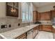 The spacious kitchen features custom cabinets, granite counters, stainless appliances, and under cabinet lighting at 9325 Verlaine Ct, Las Vegas, NV 89145