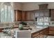 Spacious kitchen features granite countertops, wood cabinets, stainless appliances, and arched windows at 9325 Verlaine Ct, Las Vegas, NV 89145