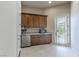 A convenient kitchenette with wooden cabinets, sink, and a microwave at 9325 Verlaine Ct, Las Vegas, NV 89145