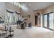 Bright living room boasts grand windows, a piano, fireplace, and soaring ceilings at 9325 Verlaine Ct, Las Vegas, NV 89145