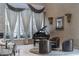 Elegant living room showcasing high ceilings, natural light, and a stylish grand piano at 9325 Verlaine Ct, Las Vegas, NV 89145