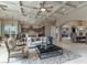 Open-concept living space featuring a coffered ceiling, tile flooring, and seamless flow to kitchen at 9325 Verlaine Ct, Las Vegas, NV 89145