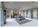 Primary bedroom featuring a sitting area, arched doorways and large windows at 9325 Verlaine Ct, Las Vegas, NV 89145