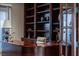 Close-up of a home office showcasing custom shelving and a beautifully crafted wooden desk at 9325 Verlaine Ct, Las Vegas, NV 89145