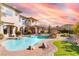 Resort-style pool and spa with lush landscaping, stone accents, and a covered outdoor living area at 9325 Verlaine Ct, Las Vegas, NV 89145