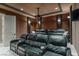 This theater room features tiered leather seating, a projector, and wall sconces at 9325 Verlaine Ct, Las Vegas, NV 89145