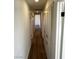 Hallway with wood flooring, white walls, and built-in storage cabinets at , Las Vegas, NV 89121