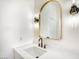 Bathroom vanity with a white countertop, modern faucet and gold trimmed mirror at 1006 Blue Lantern Dr, Henderson, NV 89015