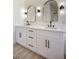 Dual sink bathroom vanity with matte black hardware, quartz countertop and wood look flooring at 1006 Blue Lantern Dr, Henderson, NV 89015