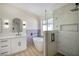 Modern bathroom with a soaking tub, glass shower, and dual vanity at 1006 Blue Lantern Dr, Henderson, NV 89015