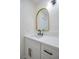 Bathroom vanity with a white countertop, gold trimmed mirror and black hardware at 1006 Blue Lantern Dr, Henderson, NV 89015