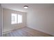 Bright bedroom featuring sleek hardwood floors, a large window, and a modern ceiling light at 1006 Blue Lantern Dr, Henderson, NV 89015