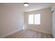 Well-lit bedroom with hardwood floors, a new window, and white walls at 1006 Blue Lantern Dr, Henderson, NV 89015