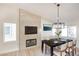 Cozy dining room featuring a fireplace, modern light fixture, and a stylish dining table with seating for six at 1006 Blue Lantern Dr, Henderson, NV 89015