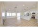 Modern kitchen featuring stainless steel appliances, a central island, and sleek white cabinetry in an open layout at 1006 Blue Lantern Dr, Henderson, NV 89015