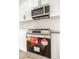 Close-up of the stainless steel oven and microwave, with white cabinets and quartz countertops at 1006 Blue Lantern Dr, Henderson, NV 89015