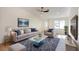 Cozy and stylish living room with a comfortable sofa, armchair, and a chic glass coffee table on a plush rug at 1006 Blue Lantern Dr, Henderson, NV 89015