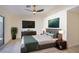 Nicely staged main bedroom with a ceiling fan, LVP flooring and modern decor at 1006 Blue Lantern Dr, Henderson, NV 89015