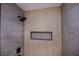 Modern shower with gray tiling, black fixtures, a recessed shelf and natural wood accent wall at 1006 Blue Lantern Dr, Henderson, NV 89015