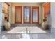 Close up of bathroom featuring a soaking tub and natural light from plantation shutters at 1059 Via Saint Lucia Pl, Henderson, NV 89011