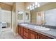 Bright bathroom features double sinks, granite counters, and neutral tile flooring at 1059 Via Saint Lucia Pl, Henderson, NV 89011