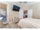 Lovely bedroom features a TV, door to balcony, closet and en-suite bathroom at 1059 Via Saint Lucia Pl, Henderson, NV 89011