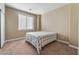 Neutral-toned bedroom features a large window and a comfortable bed at 1059 Via Saint Lucia Pl, Henderson, NV 89011