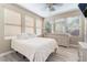 Sun-filled bedroom features a large window and light wood laminate flooring at 1059 Via Saint Lucia Pl, Henderson, NV 89011