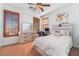 Cozy bedroom with a bed, desk, dresser, ceiling fan and natural light at 1059 Via Saint Lucia Pl, Henderson, NV 89011