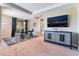 Bedroom featuring a decorative cabinet, TV, and access to a private balcony at 1059 Via Saint Lucia Pl, Henderson, NV 89011