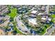 Aerial view showcases community center with pool, palm trees, grassy areas, and surrounding residential homes at 1059 Via Saint Lucia Pl, Henderson, NV 89011