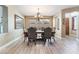 Formal dining room with elegant chandelier, decorative mirror and dark wood table at 1059 Via Saint Lucia Pl, Henderson, NV 89011