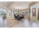 Spacious dining room with wood floors and an elegant chandelier at 1059 Via Saint Lucia Pl, Henderson, NV 89011