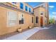 Beige stucco home with desert landscaping and covered entry on a sunny day at 1059 Via Saint Lucia Pl, Henderson, NV 89011