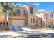 Inviting two-story home with a stucco exterior, and three car garage at 1059 Via Saint Lucia Pl, Henderson, NV 89011