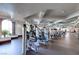 Well-equipped gym featuring modern exercise machines and ample workout space with view of outside palm tree at 1059 Via Saint Lucia Pl, Henderson, NV 89011