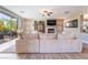 Comfortable living room with plush sofa, fireplace, and large sliding glass door that leads to an outdoor patio at 1059 Via Saint Lucia Pl, Henderson, NV 89011