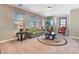 Cozy living room showcasing natural light, comfortable seating, and a decorative rug at 1059 Via Saint Lucia Pl, Henderson, NV 89011