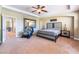 Comfortable main bedroom featuring plush carpet, ceiling fan, and decorative accents at 1059 Via Saint Lucia Pl, Henderson, NV 89011