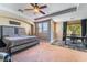 Spacious main bedroom featuring a king-size bed, a seating area, and access to a balcony at 1059 Via Saint Lucia Pl, Henderson, NV 89011