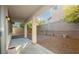 Covered patio and gravel backyard space with a block wall and three potted plants at 11204 Newbury Hills Ave, Las Vegas, NV 89138