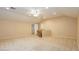 Spacious bonus room with carpet, a ceiling fan and an entryway to a storage room at 11204 Newbury Hills Ave, Las Vegas, NV 89138