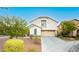 Inviting home featuring desert landscaping, attached two-car garage, and classic architecture at 11204 Newbury Hills Ave, Las Vegas, NV 89138